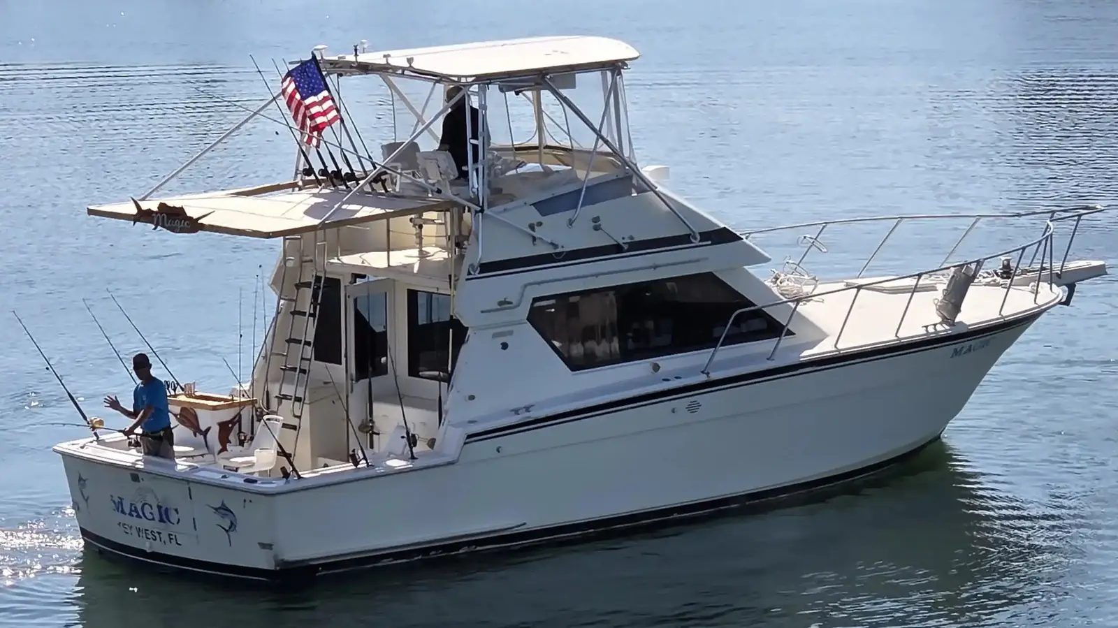 The Magic, a 42 foot Hatteras sportfishing boat, cutting across calm turquoise water near Key West