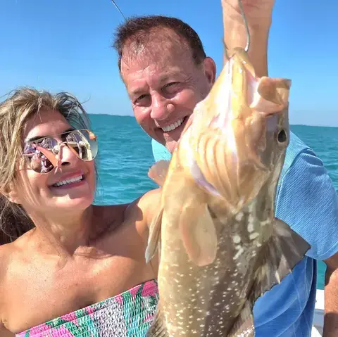 An angler holding a gag grouper caught near Key West