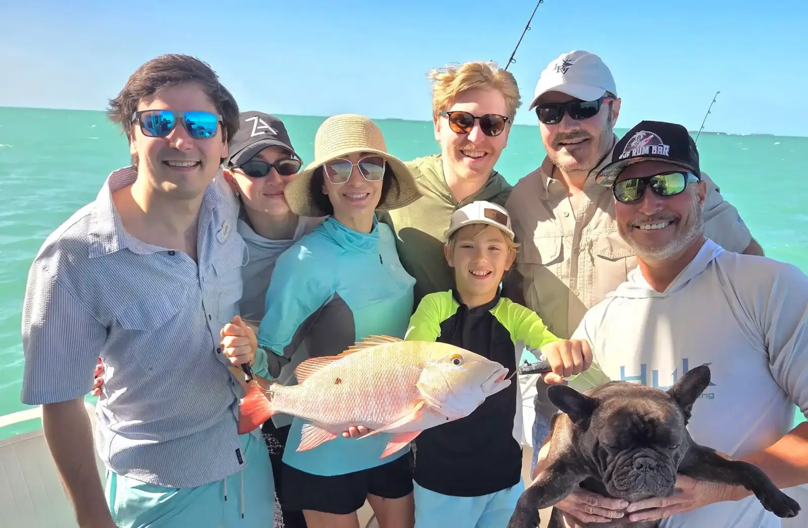 Three guests holding a blacktip shark on a shark fishing trip near Key West