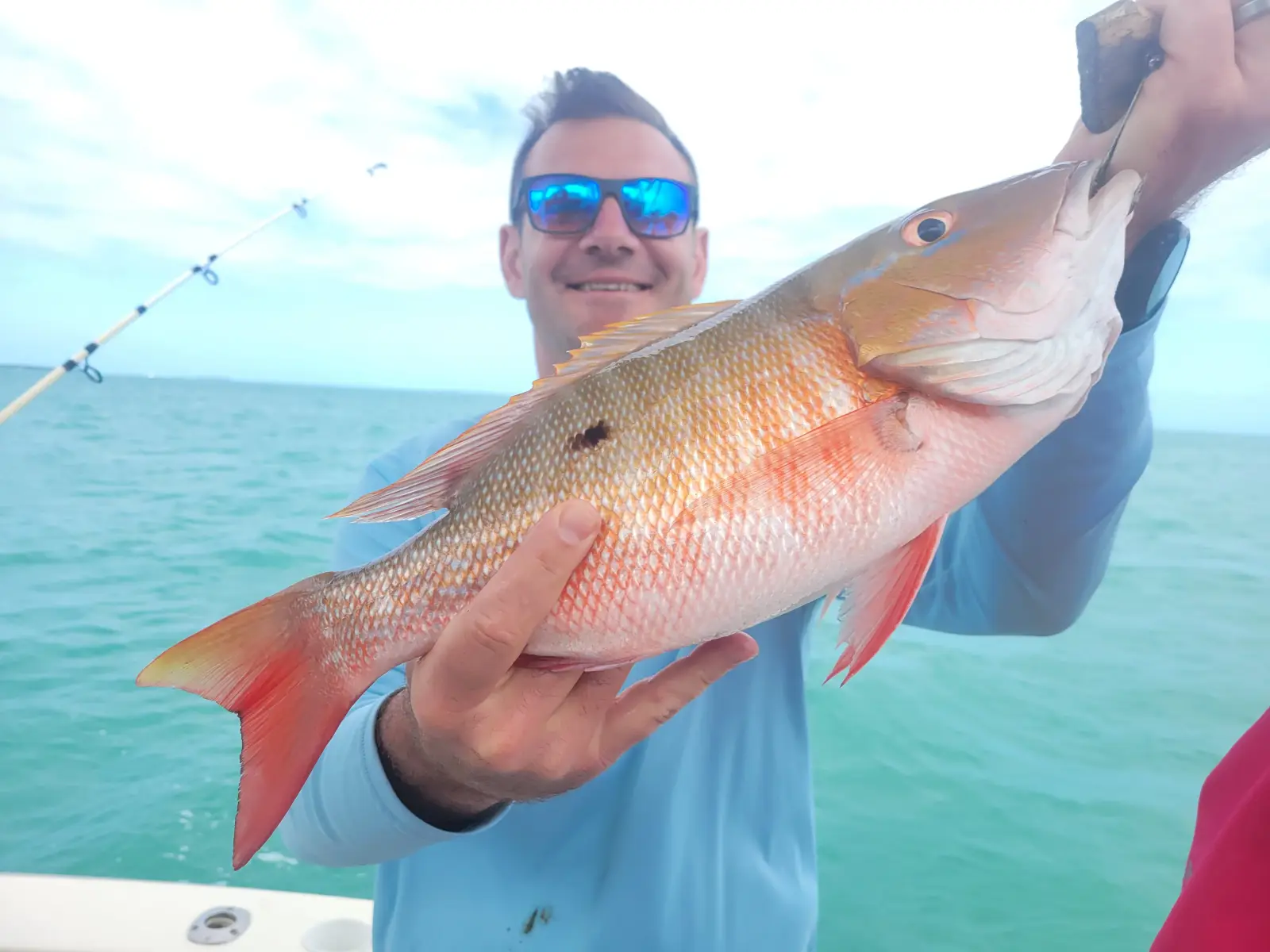 Angler holding a mangrove snapper caught near Key West