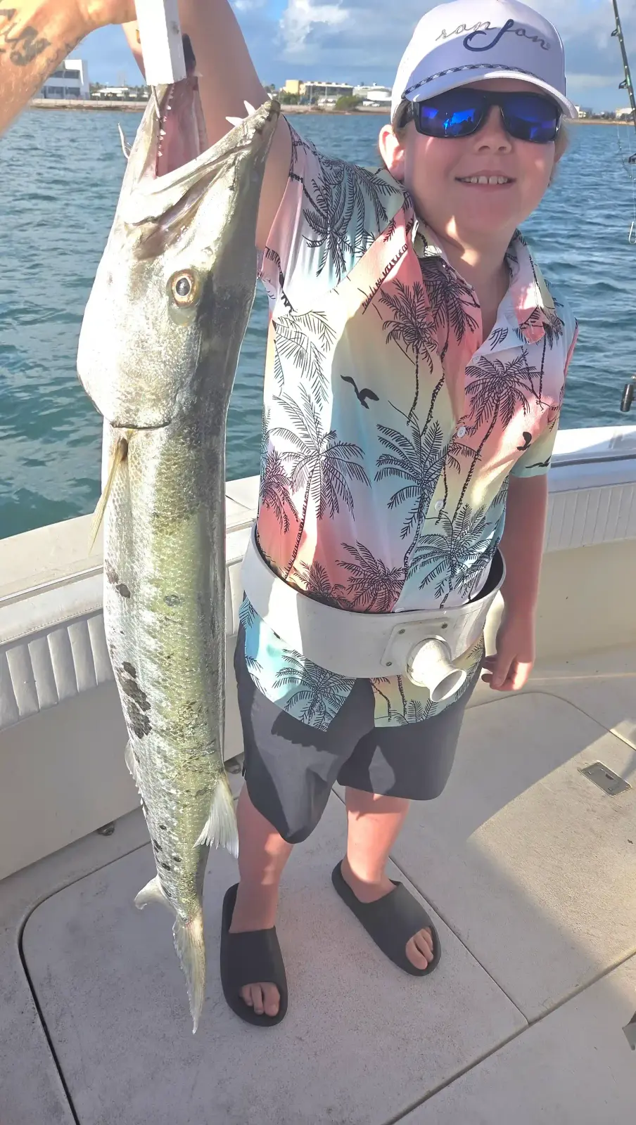 A young angler holding a barracuda caught near Key West