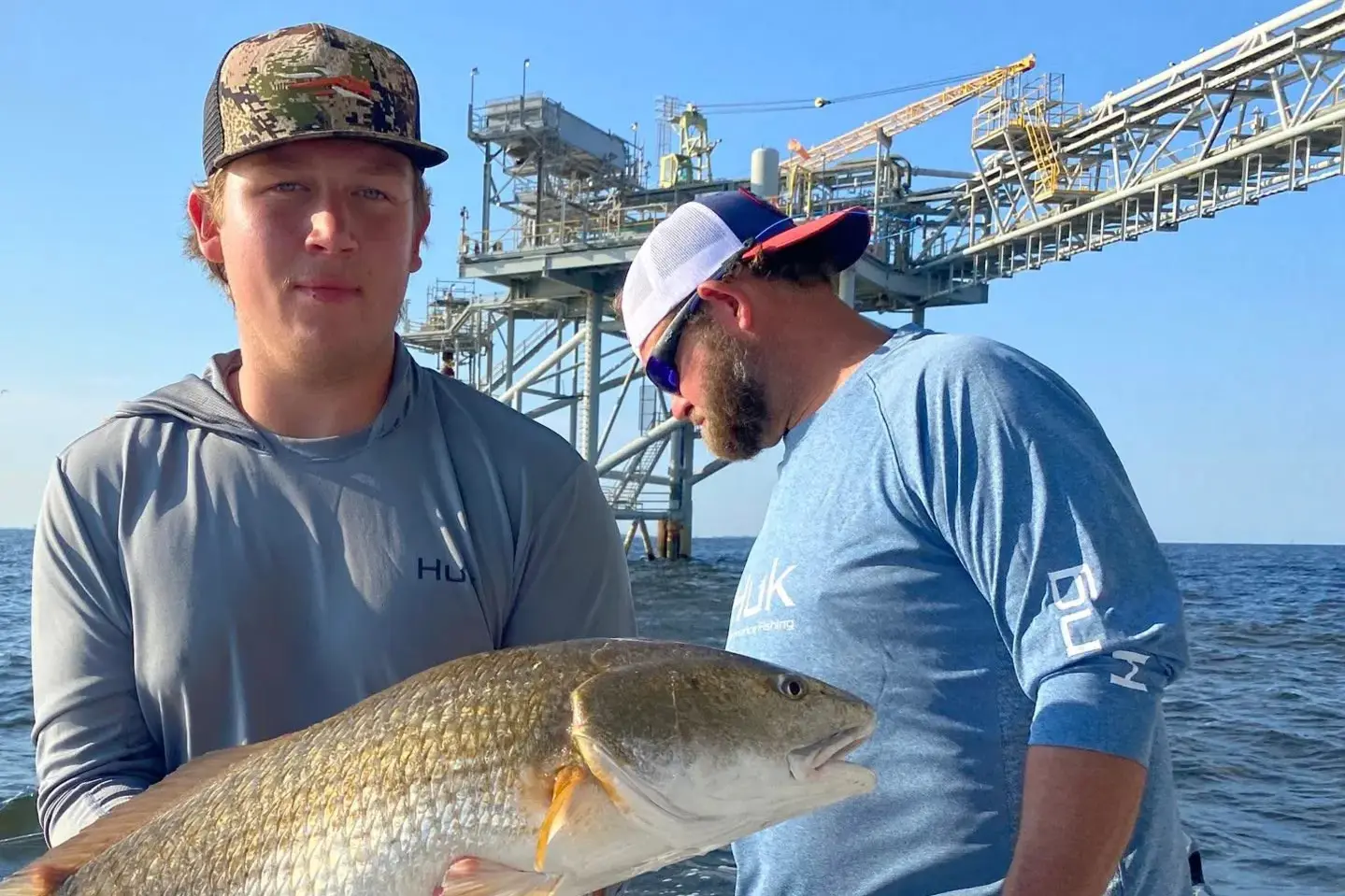 Two anglers holding a redfish near Key West