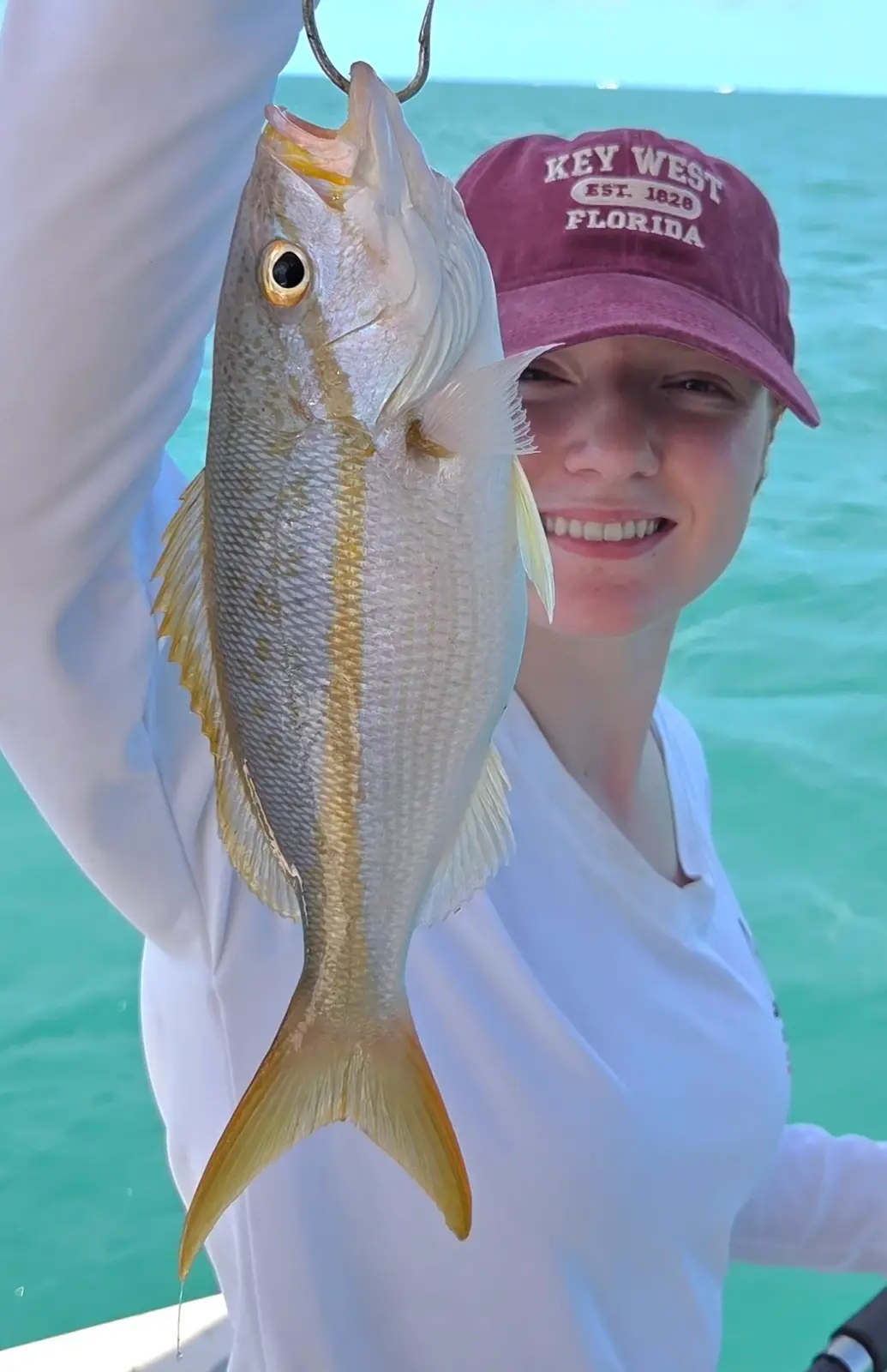 An angler holding a yellowtail snapper near Key West